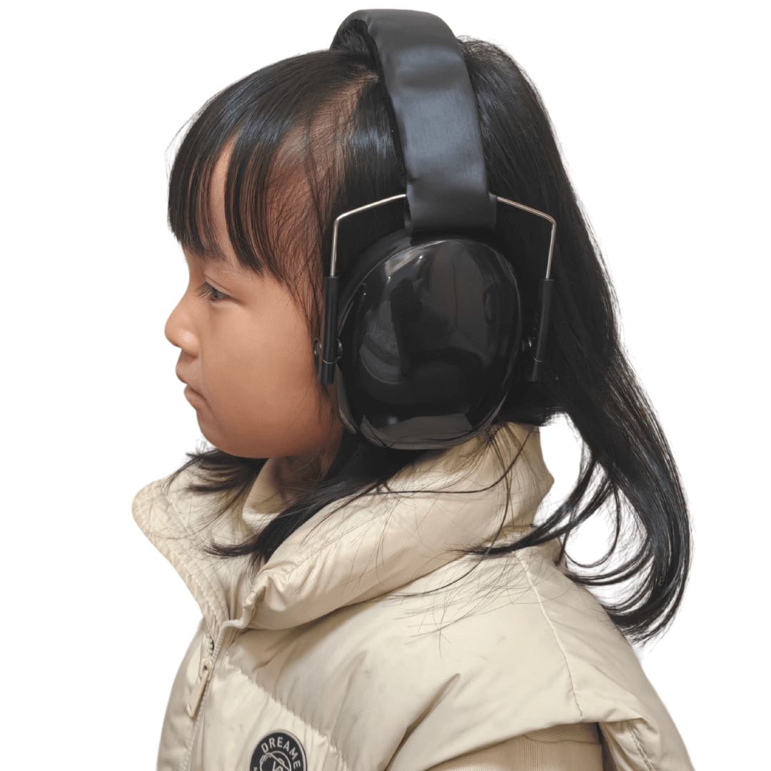 side view of a kid wearing black ear defender