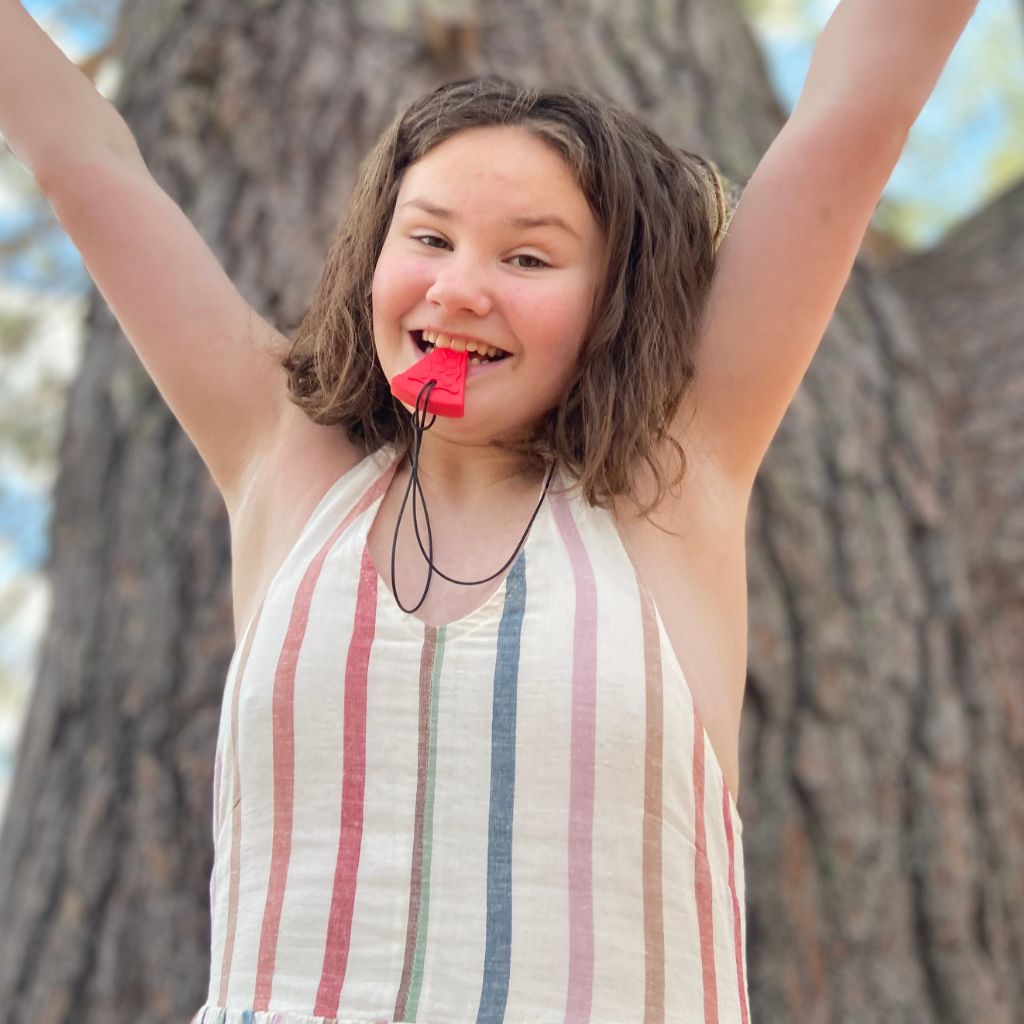 teenage girl biting ark pizza chew necklace