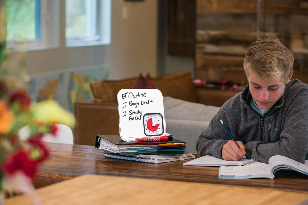 teenager studying while using time timer easer mod dry eraser board