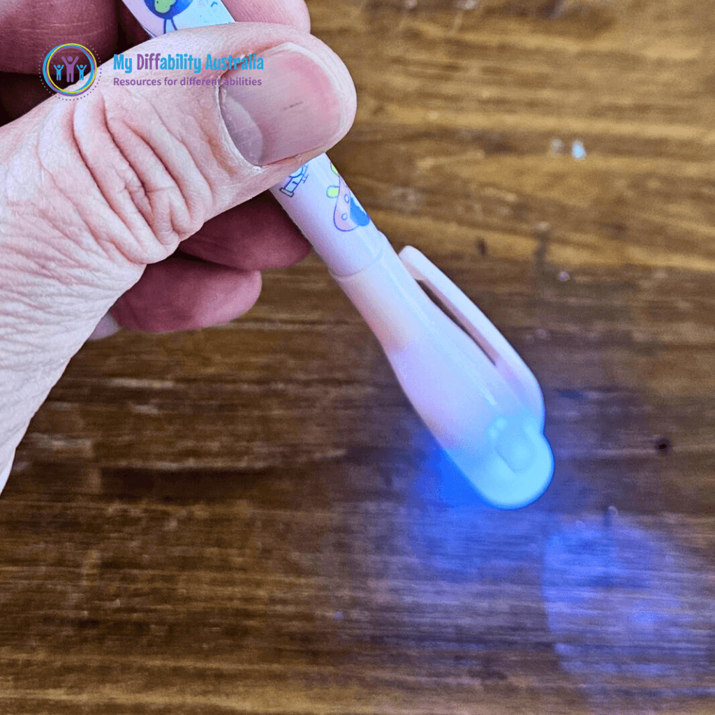 uv invisible spy pen side view while being hold by one hand zoom in