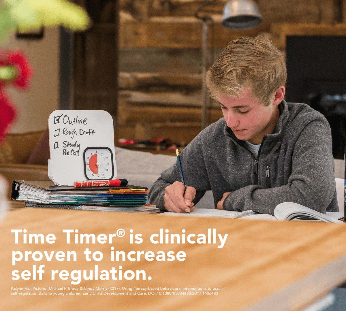 boy writing while using time timer mod and dry eraser board