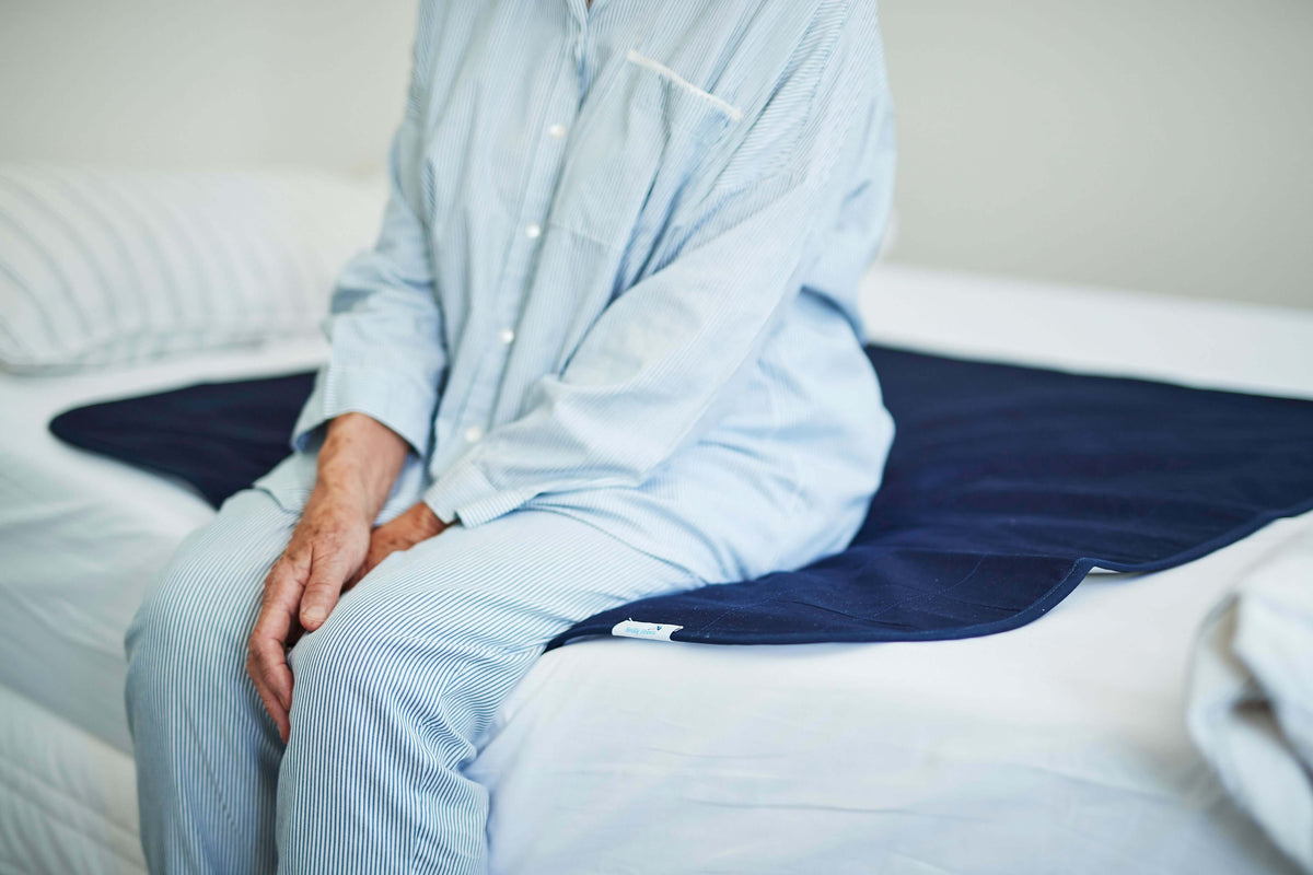 Woman Seating on a bed pad