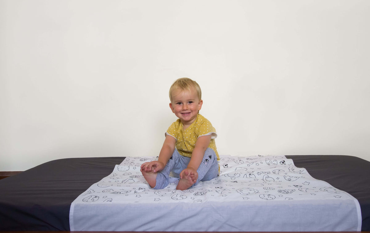 brolly sheet on gray bed cover