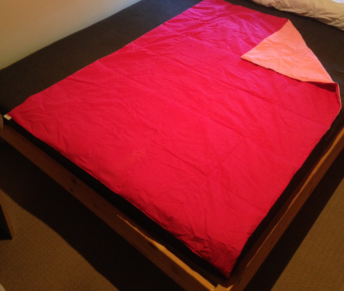 pink weighted blanket double size on  a bed 