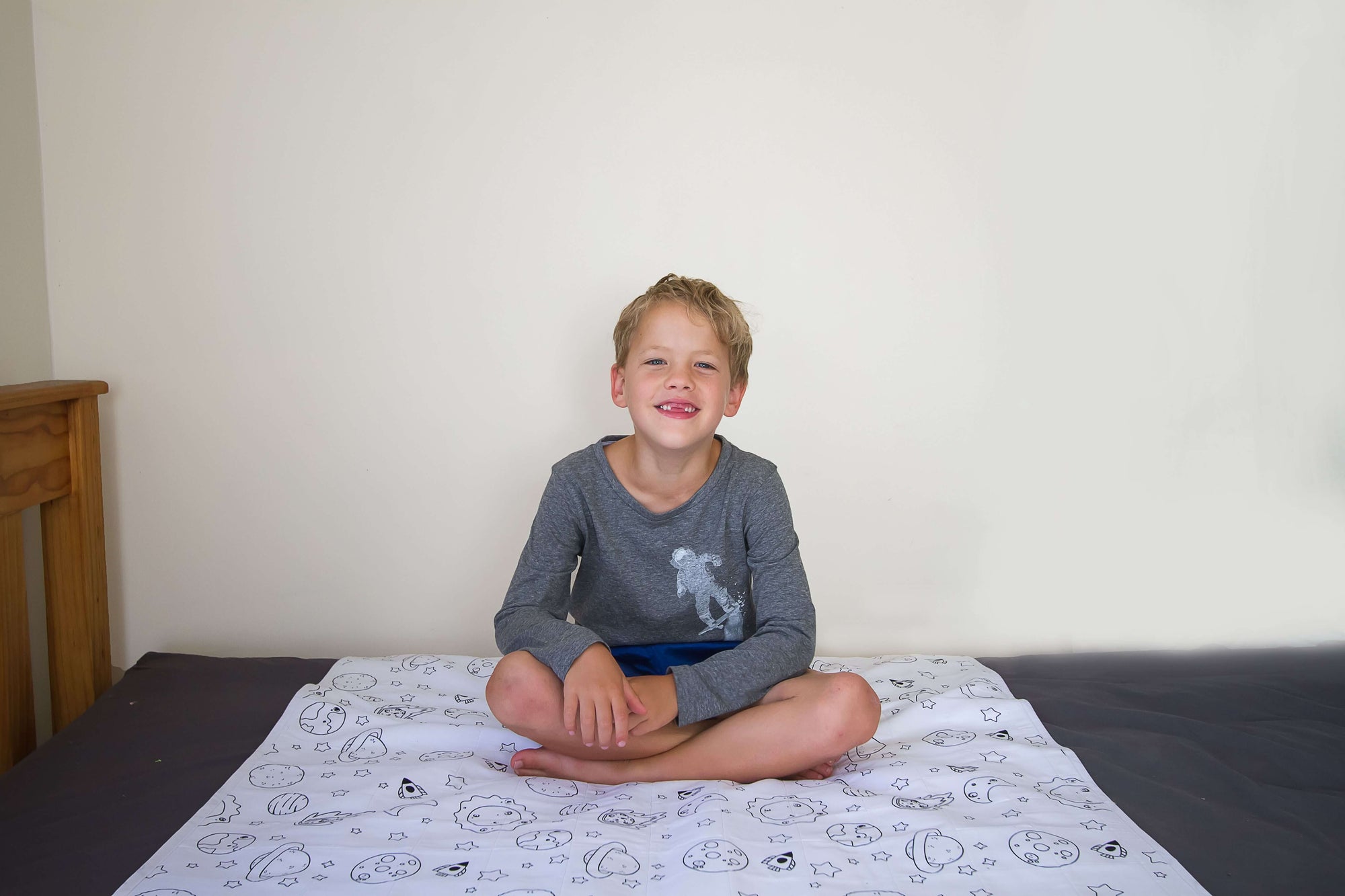 kid seating on a brolly sheet space