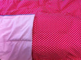 close up detail of pink weighted blanket cover with red polka dots and pink